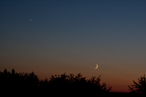Photo: Crescent Moon and Planet Venus float in sunset sky. Photo by James Guilford