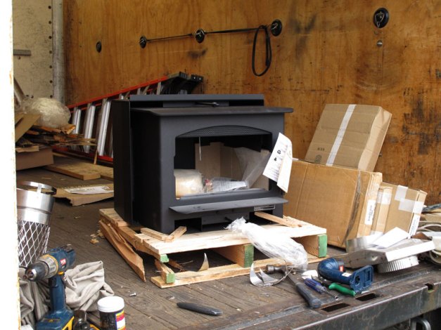 Photo: Stove on broken pallet in delivery truck.