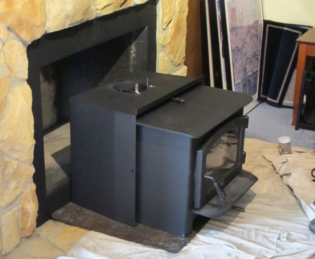 Photo: Stove insert aligned with fireplace opening.