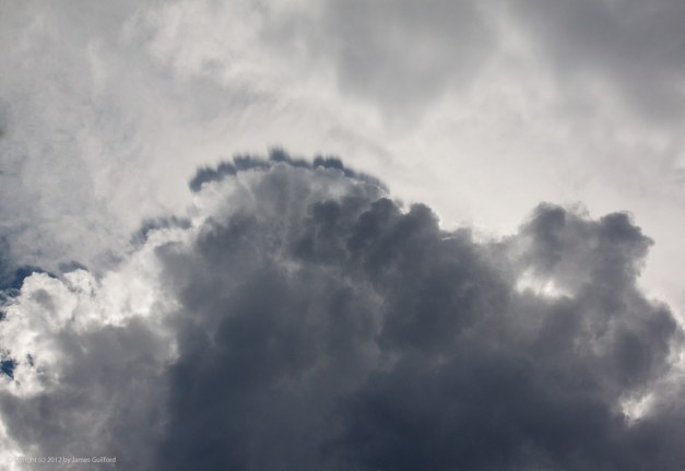 Photo: Backlit storm clouds loom overhead. Photo by James Guilford.