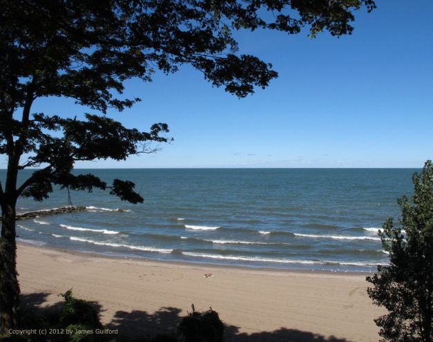 Photo: Broad sandy beach with only one person visible. Photo by James Guilford.