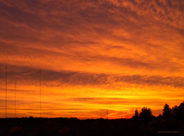 Photo: Glowing sunrise over radio antenna site. Photo by James Guilford.