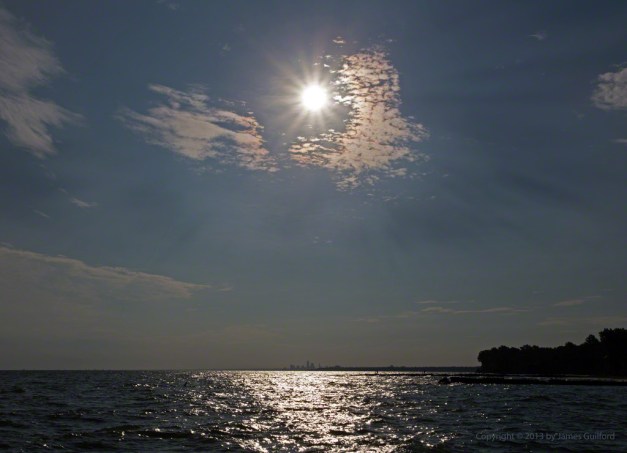 Photo: Sun over Lake Erie with Cleveland Skyline in distance. Photo by James Guilford.