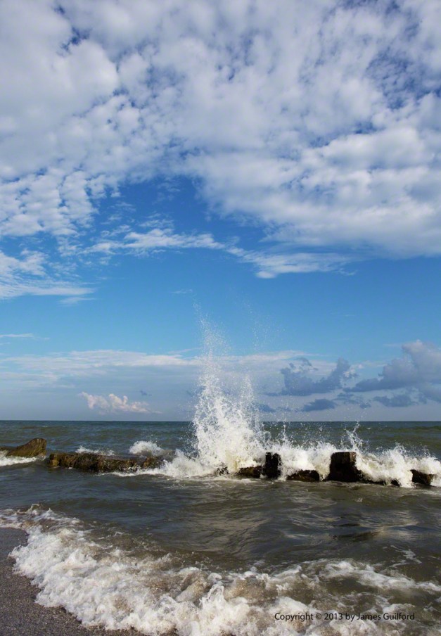 Photo: Waves crashing on a Lake Erie break wall. Photo by James Guilford.