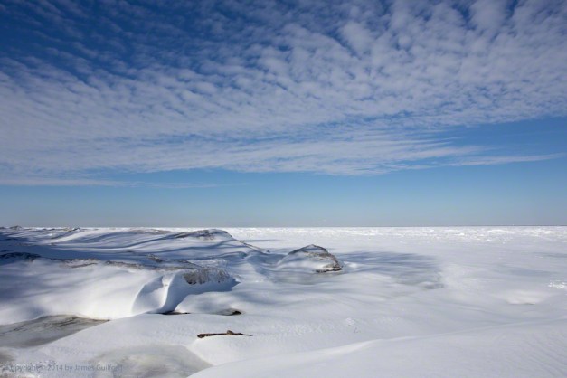 Photo: Piles of broken ice, covered with snow, under a blue sky along the south shore of Lake Erie. Photo by James Guilford.