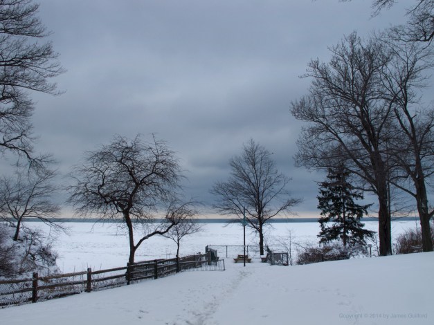 Photo: Dark skies dominate view of lakefront park. Photo by James Guilford.