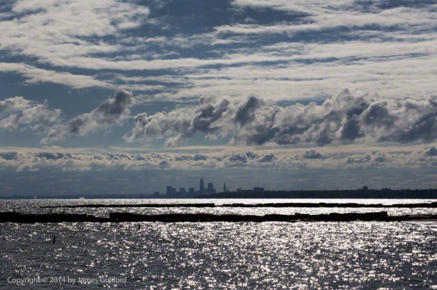 Photo: Flowing Clouds Move over Shadowed Cleveland Skyline. Photo by James Guilford