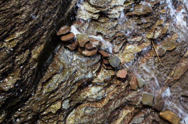 Photo: A line of pebbles arranged by a child in a waterfall. Photo by James Guilford.