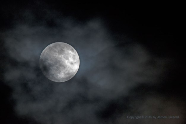Photo: Pre-eclipse, bright Moon amongst thin clouds. Photo by James Guilford.