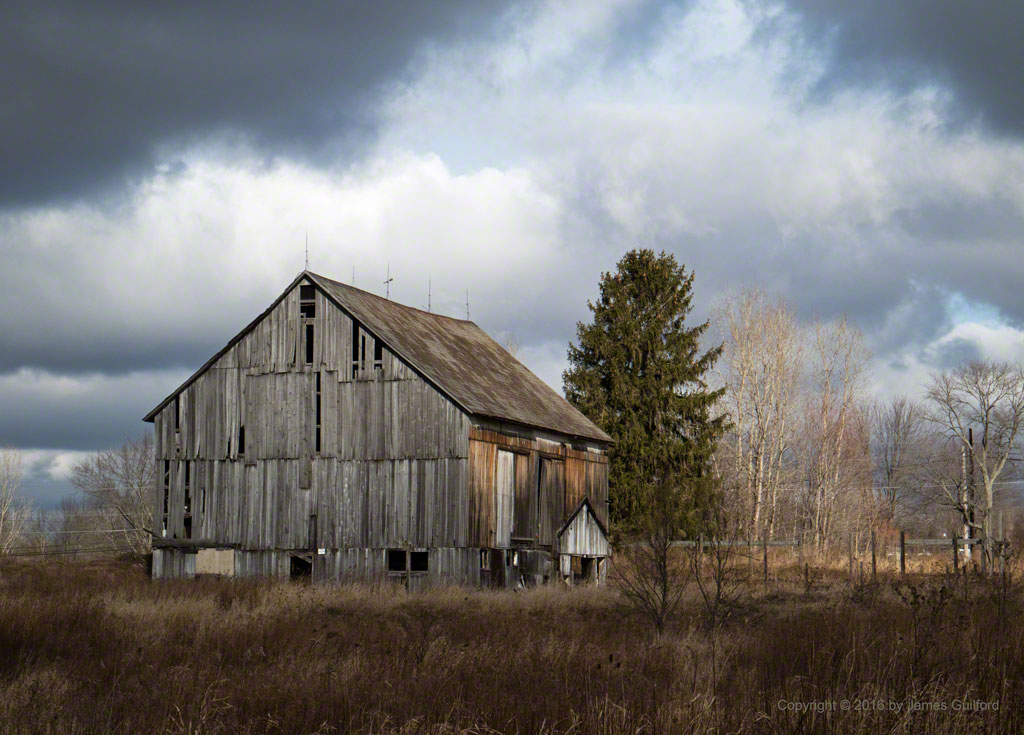 Photo: Old weathered barn and dramatic sky. Photo by James Guilford.