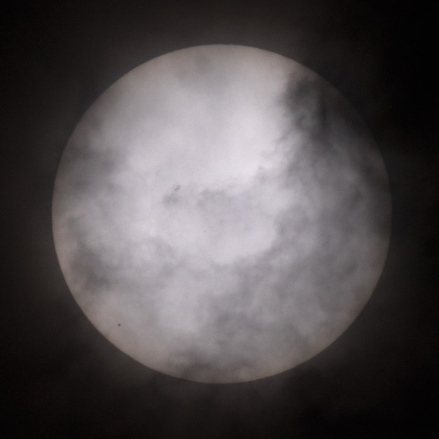 Photo: Clouds interfere with view of Mercury's transit. Photo by James Guilford.