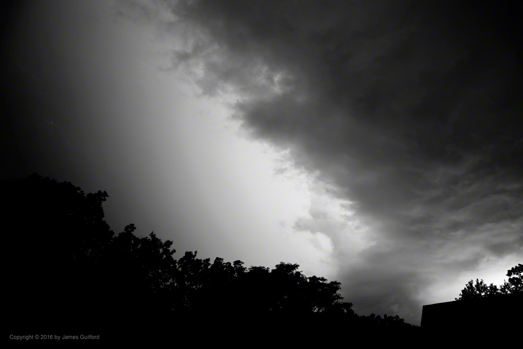 Photo: Intense hidden lightning illuminates the sky. Photo by James Guilford.
