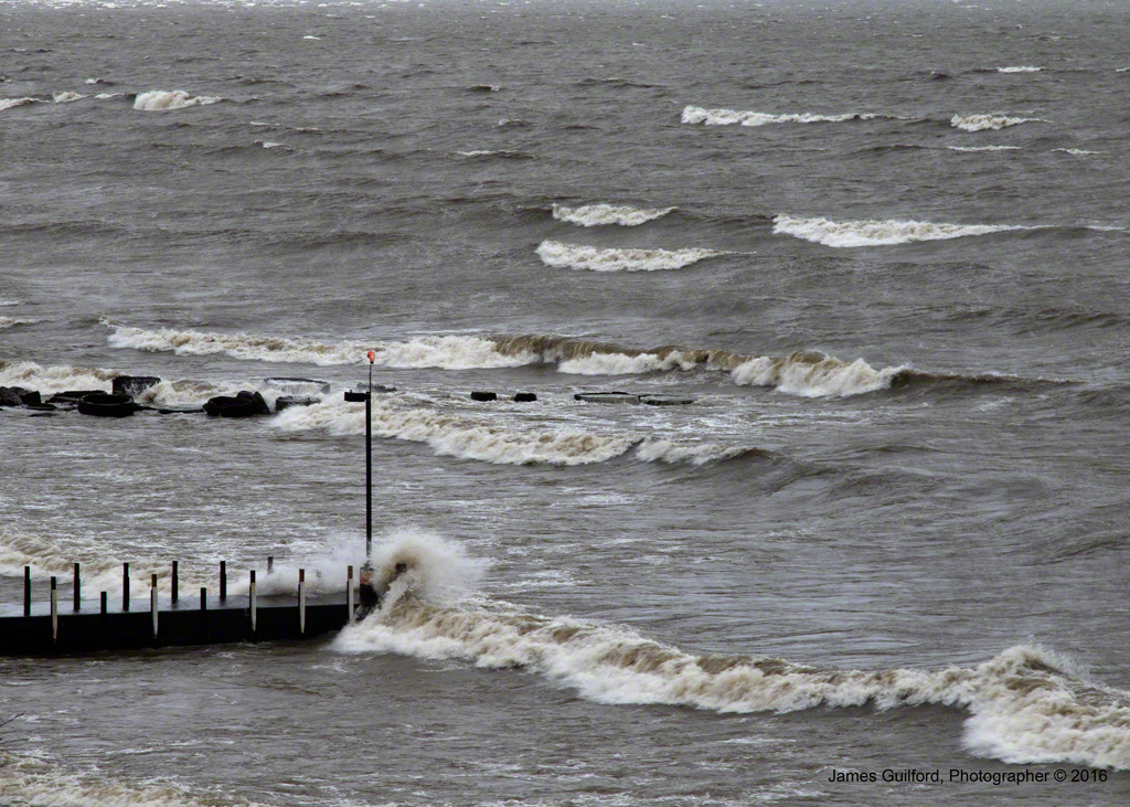 Photo: Breakwall is Pummeled by Wind-Driven Waves. Photo by James Guilford.
