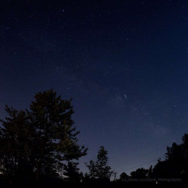 Photo: The streak of a small meteor with the Milky Way as background. Photo by James Guilford.