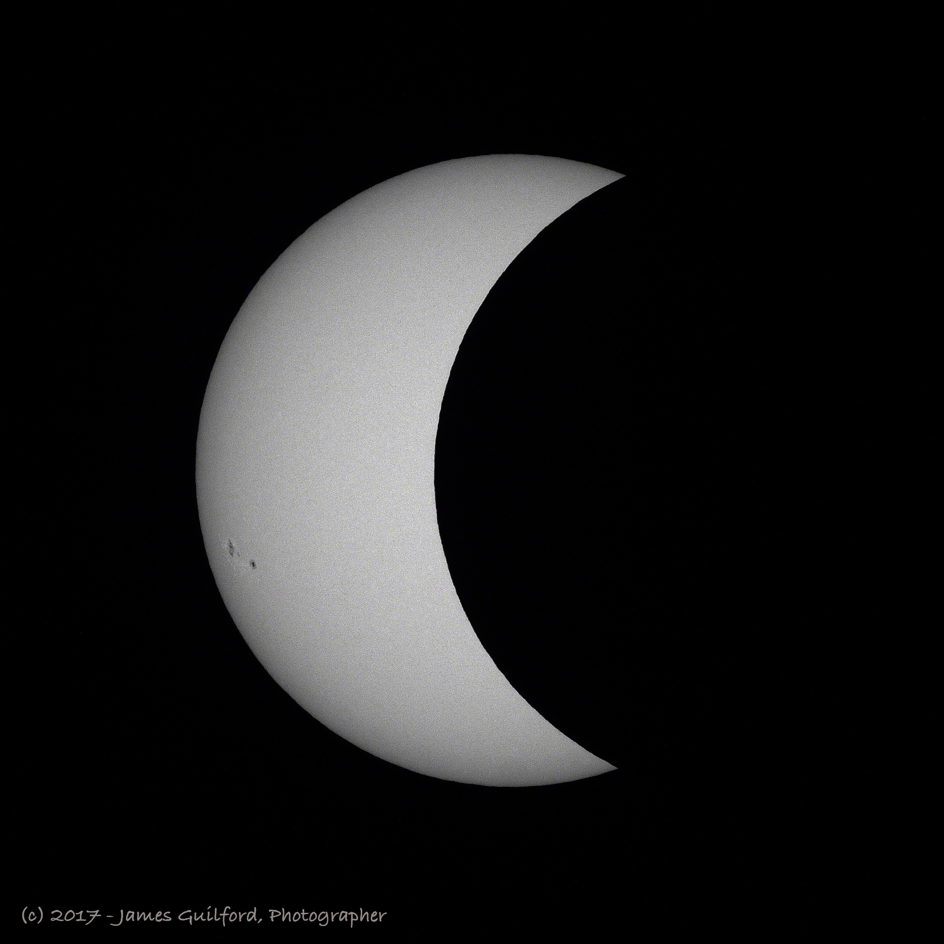 Photo: Solar eclipse in progress, moving towards maximum coverage. Photo by James Guilford.