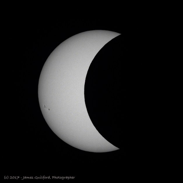 Photo: Solar eclipse in progress, moving towards maximum coverage. Photo by James Guilford.