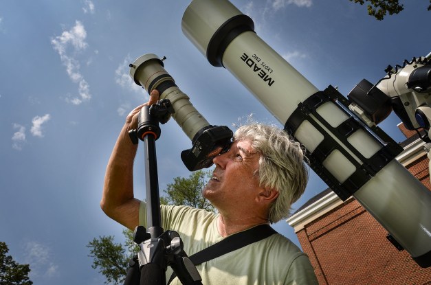 Photo: Photographer with camera and telescope. Credit: Dave Dreimiller.