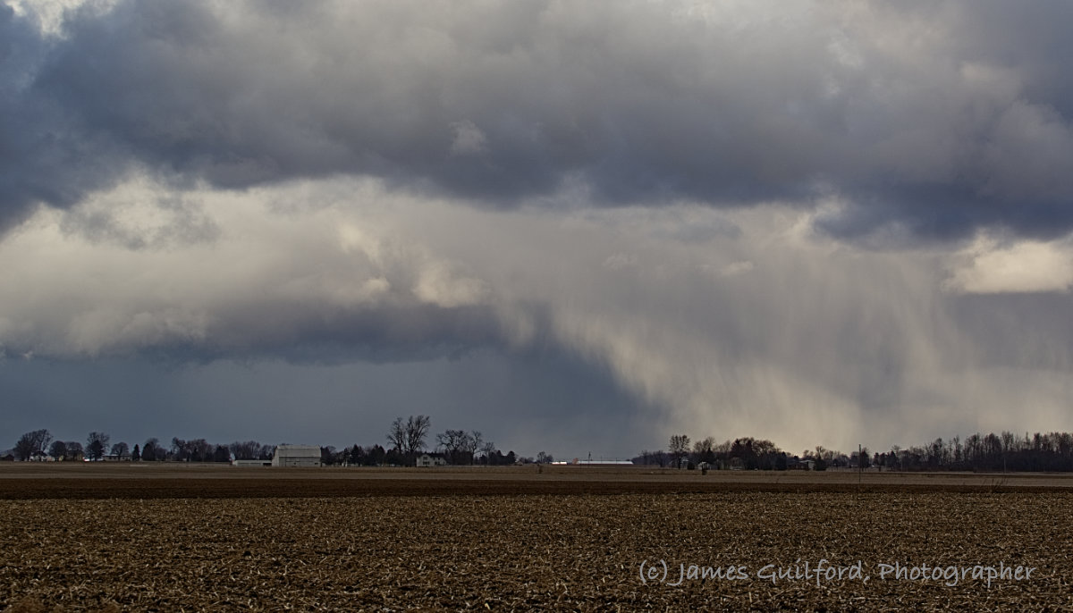 Photo: Snow and graupel falling from their bases make the clouds appear to be collapsing. Photo by James Guilford
