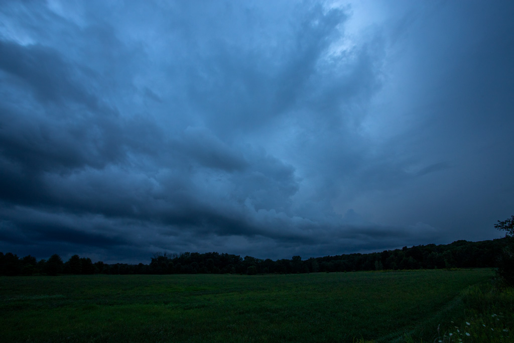 Photo: Darkness Falls. Clouds cover the sky and the blue of nightfall tints the scene. Photo by James Guilford.