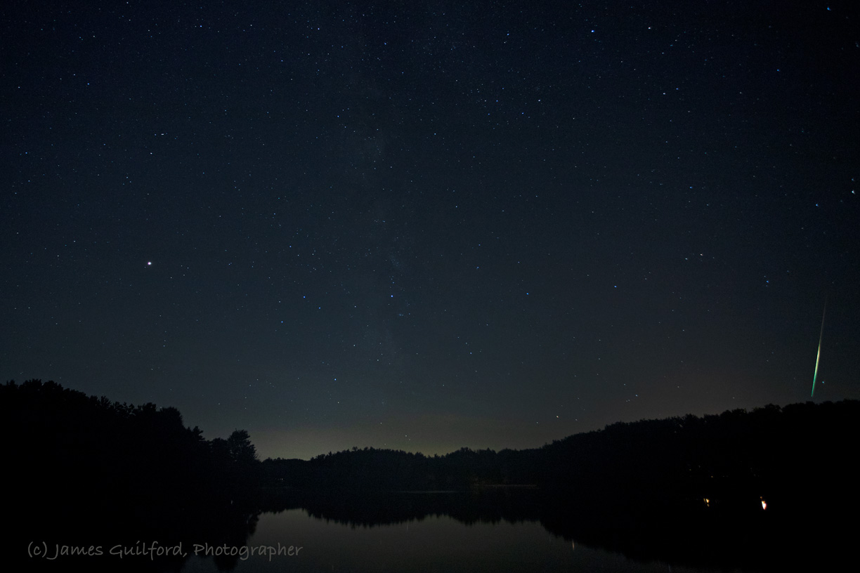 Photo: Here is an extremely bright, and very slow fireball just within the right edge of the frame. I remember the streak appearing warm in color, yellowish, but the camera recorded the spectral colors you see here. The lights near the bottom of the picture are artificial lights onshore, not reflections of stars. Photo by James Guilford.