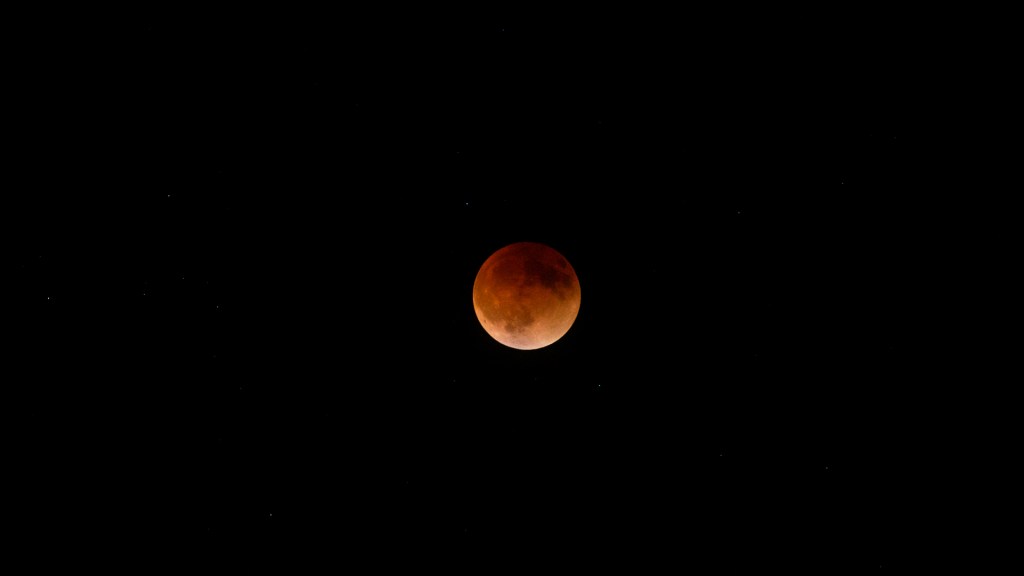 Total Lunar Eclipse of May 15 - 16, 2022, at 12:30 a.m., EDT. Some viewers may be able to see several white spots in the dark space around Moon -- stars within the constellation Libra -- better visible in the original photograph. Photo by James Guilford
